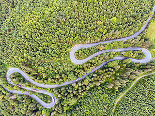 Image showing Summer mountain road crossing through forest