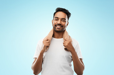 Image showing smiling indian man with towel over grey background