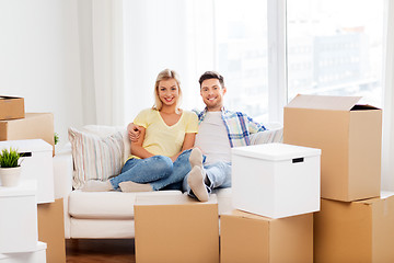 Image showing happy couple with boxes moving to new home