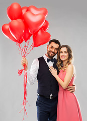 Image showing happy couple with red heart shaped balloons