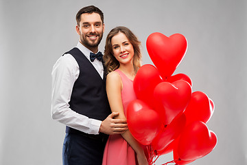 Image showing happy couple with red heart shaped balloons