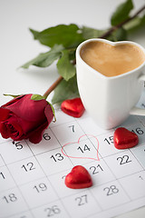 Image showing close up of calendar, hearts, coffee and red rose