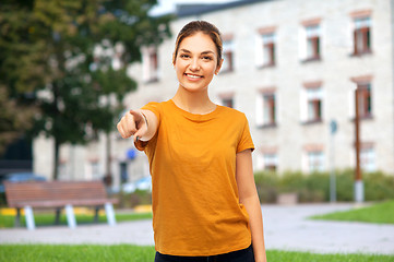 Image showing teenage girl pointing finger at you over campus