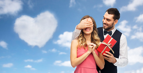 Image showing happy man giving woman surprise present