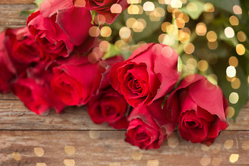 Image showing close up of red roses bunch over festive lights