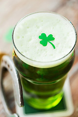 Image showing close up of glass of green beer with shamrock