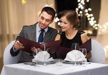 Image showing couple with menus at restaurant