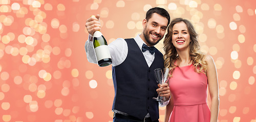 Image showing happy couple with bottle of champagne and glasses