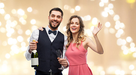 Image showing happy couple with bottle of champagne and glasses