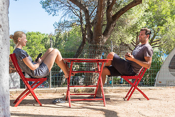 Image showing Couple on vacations resting in front of bungalow house at camping site in pure nature. Family vacation travel, holiday trip Sardigna, Italy