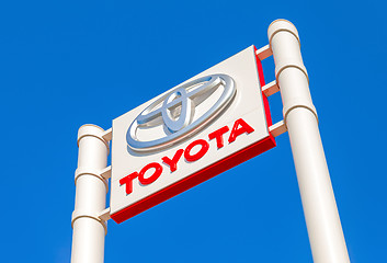Image showing Toyota automobile dealership sign against the blue sky backgroun