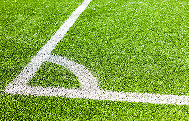 Image showing White lines marking on green grass in the corner of the soccer o