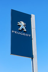 Image showing Official dealership sign of Peugeot against the blue sky backgro