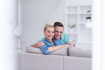 Image showing couple relaxing at  home with tablet computers