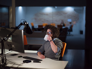 Image showing man working on computer in dark startup office