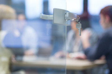 Image showing Open  glass door with keys