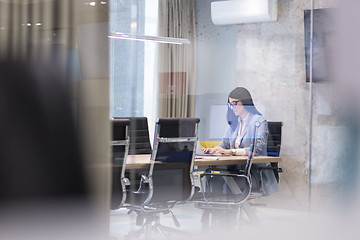 Image showing businesswoman using a laptop in startup office