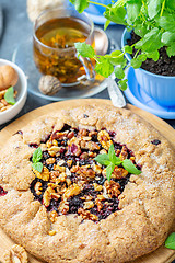 Image showing Homemade currant pie and a cup of green tea.