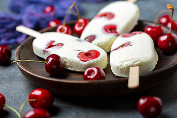 Image showing Artisanal vanilla sundae with red cherry.