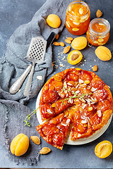 Image showing Sliced caramelized tarte tatin pie with apricots.