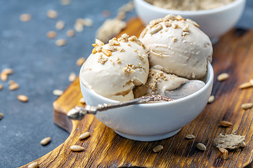 Image showing Ice cream with halva and sunflower seeds close up.