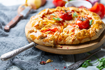 Image showing Open pie with potatoes, bacon and tomatoes.