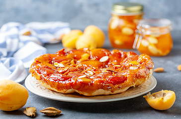 Image showing Apricot and almond tarte tatin on a white plate.