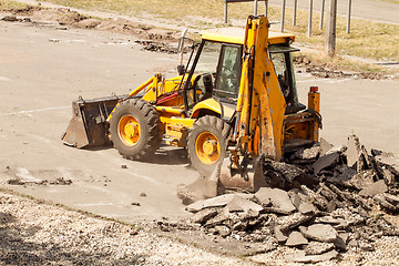 Image showing Tractor Dismantles Asphalt