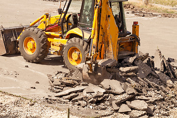 Image showing Tractor Dismantles Asphalt