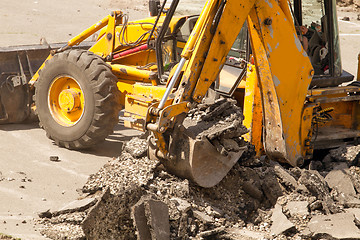 Image showing Tractor Dismantles Asphalt