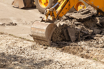 Image showing Tractor Dismantles Asphalt