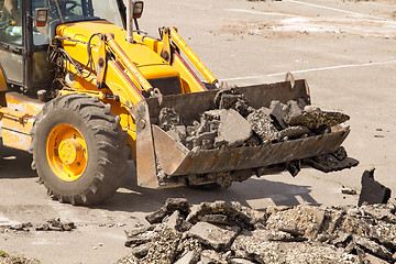 Image showing Tractor Dismantles Asphalt