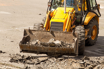 Image showing Tractor Dismantles Asphalt