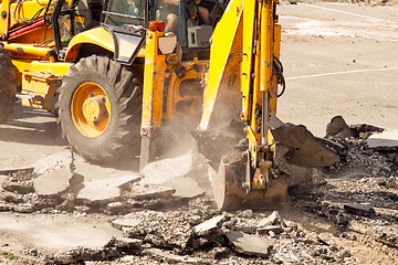 Image showing Tractor Dismantles Asphalt