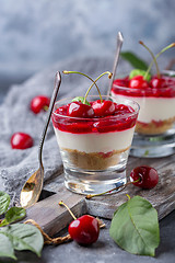 Image showing Light cheesecake with cherry jelly in a glass.