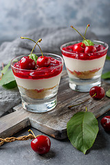 Image showing Sweet cherry cheesecake in glasses.