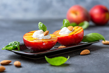 Image showing Grilled peach with honey, yogurt and almonds.