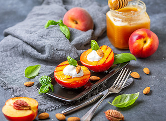 Image showing Grilled peaches with yogurt,honey and green basil.