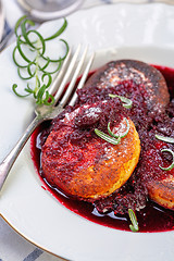 Image showing Curd pancakes with cherry sauce with rosemary.