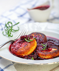 Image showing Curd fritters with cherry sauce and rosemary.