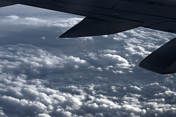 Image showing Large airliner along clouds