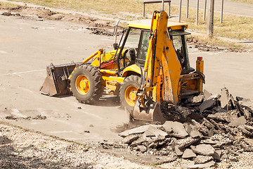 Image showing Tractor Dismantles Asphalt