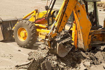 Image showing Tractor Dismantles Asphalt