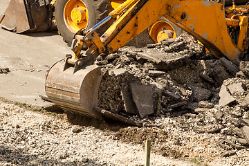 Image showing Tractor Dismantles Asphalt