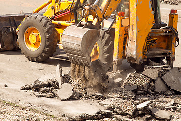 Image showing Tractor Dismantles Asphalt