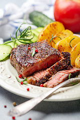 Image showing Entrecote with fried potatoes and cucumber.