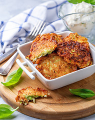 Image showing Zucchini fritters with sour cream sauce.