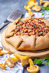 Image showing Traditional pie (Galette) with wild chanterelles.