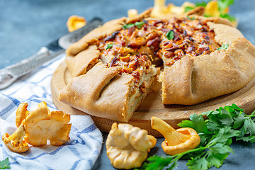 Image showing Sliced pie (Galette) with wild chanterelles.