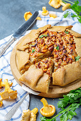 Image showing Sliced homemade pie with wild chanterelles.